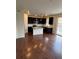 Modern kitchen featuring dark cabinetry, granite countertops, and a large island with pendant lighting at 10611 Casper St, Parker, CO 80134