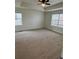 Spacious Primary bedroom with tray ceilings, a ceiling fan, and natural light from the windows at 10611 Casper St, Parker, CO 80134