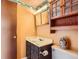 A small bathroom with patterned wallpaper at 12407 E Louisiana Ave, Aurora, CO 80012