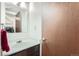 A half bathroom with a single sink vanity and door to the laundry room at 12407 E Louisiana Ave, Aurora, CO 80012