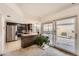 Well-lit kitchen featuring stainless steel appliances, breakfast bar, and access to an outdoor patio area at 12407 E Louisiana Ave, Aurora, CO 80012