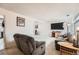 Cozy living room featuring plush seating, neutral carpet, and ample space for relaxation and entertainment at 12407 E Louisiana Ave, Aurora, CO 80012