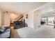 Spacious living area with neutral carpet, staircase access, and an open layout perfect for entertaining guests at 12407 E Louisiana Ave, Aurora, CO 80012