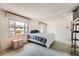 Spacious bedroom featuring a large window, comfortable bed, neutral color palette, and plenty of closet space at 12407 E Louisiana Ave, Aurora, CO 80012