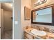 Bathroom featuring a vanity with mirror and nearby closet in neutral tones at 18843 E Colorado Dr, Aurora, CO 80017