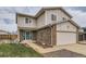 Home with a two-car garage, brick accents, a well-maintained lawn, and a blue-green door at 18843 E Colorado Dr, Aurora, CO 80017