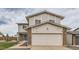 Charming two-story home features a two-car garage, brick accents, and neutral siding at 18843 E Colorado Dr, Aurora, CO 80017