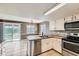 Kitchen with granite countertops, stainless steel appliances, and a dining area view at 18843 E Colorado Dr, Aurora, CO 80017