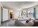 Bright bedroom featuring an ensuite bathroom, dresser, makeup vanity, plush carpet, and ample natural light at 18843 E Colorado Dr, Aurora, CO 80017