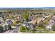 Overhead view of the property surrounded by lush greenery and neighboring homes in a suburban setting at 3055 E 133Rd Cir, Thornton, CO 80241