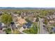 Wide aerial shot showing the home nestled in a vibrant neighborhood with tree-lined streets at 3055 E 133Rd Cir, Thornton, CO 80241