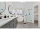 Bright bathroom with double vanity, soaking tub, and a glass-enclosed shower at 3055 E 133Rd Cir, Thornton, CO 80241