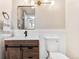Cozy bathroom features a rustic vanity, modern fixtures, and crisp white walls at 3055 E 133Rd Cir, Thornton, CO 80241