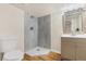 Modern bathroom with tiled shower and vanity featuring storage at 3055 E 133Rd Cir, Thornton, CO 80241