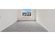 Empty carpeted bedroom features a large window with a neighborhood view at 3055 E 133Rd Cir, Thornton, CO 80241