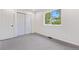 A bright, carpeted bedroom with a double door closet and large window at 3055 E 133Rd Cir, Thornton, CO 80241