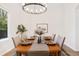Cozy dining room set with an elegant chandelier, table setting, and natural light at 3055 E 133Rd Cir, Thornton, CO 80241