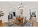 Open dining area with modern lighting, table set for dinner, and seamless transition to the living spaces at 3055 E 133Rd Cir, Thornton, CO 80241