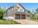 Side view of a two-story home with brick accents, a two-car garage, and a white picket fence at 3055 E 133Rd Cir, Thornton, CO 80241