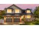 Home exterior featuring a brick facade, two-car garage, covered porch, and well-lit windows at dusk at 3055 E 133Rd Cir, Thornton, CO 80241