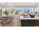 Bright kitchen and dining area featuring a large window, modern appliances, and stylish decor at 3055 E 133Rd Cir, Thornton, CO 80241
