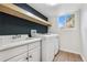 Functional laundry room equipped with a sink, washer, dryer, and storage shelf at 3055 E 133Rd Cir, Thornton, CO 80241