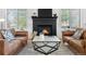 Inviting living room with a fireplace, plush sofas, and a stylish coffee table at 3055 E 133Rd Cir, Thornton, CO 80241