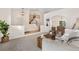 Open-concept living room featuring high ceilings, a staircase, and an archway leading to the dining area at 3055 E 133Rd Cir, Thornton, CO 80241