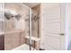 Close up of a tiled shower with glass door and built in bench in primary bathroom at 10111 Inverness Main St # 228, Englewood, CO 80112