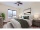 Well-lit bedroom with a large window, comfortable bed, and stylish decor at 10111 Inverness Main St # 228, Englewood, CO 80112