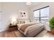 Bright bedroom with a large window offering neighborhood views, complete with a cozy bed at 10111 Inverness Main St # 228, Englewood, CO 80112