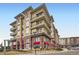 Beautiful condominium building featuring brick and tan siding, multiple stories, and private balconies at 10111 Inverness Main St # 228, Englewood, CO 80112