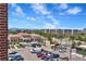Scenic view of the building exterior with parking, city skyline, and mountain backdrop on a bright, sunny day at 10111 Inverness Main St # 228, Englewood, CO 80112