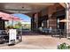 Outdoor patio seating at a restaurant with umbrellas and people enjoying a meal at 10111 Inverness Main St # 228, Englewood, CO 80112