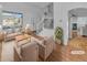 Staged living room featuring hardwood floors, abundant natural light, and an open staircase to the second floor at 9884 Florence Pl, Highlands Ranch, CO 80126