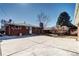 The backyard includes a large concrete patio, brick home exterior, and landscaping at 2921 E Colorado Ave, Denver, CO 80210