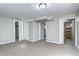Finished basement featuring neutral carpet, doors, and a glimpse of the kitchen at 2921 E Colorado Ave, Denver, CO 80210