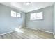 Inviting bedroom with two large windows, light wood floors, and light gray walls at 2921 E Colorado Ave, Denver, CO 80210