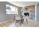 Bright dining area featuring a stone accent wall, neutral walls, and a modern table set at 2921 E Colorado Ave, Denver, CO 80210
