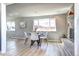 Open concept dining room with hardwood floors, a view of the yard, and a decorative fireplace at 2921 E Colorado Ave, Denver, CO 80210