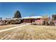 Charming brick home with a manicured lawn, sidewalk, and mature trees at 2921 E Colorado Ave, Denver, CO 80210