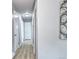 Hallway featuring hardwood floors and white doors leading to bedrooms and bathrooms at 2921 E Colorado Ave, Denver, CO 80210