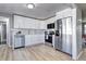 Modern kitchen featuring stainless steel appliances, white cabinets, and hardwood floors at 2921 E Colorado Ave, Denver, CO 80210