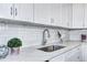 Kitchen featuring quartz countertops, white subway tile backsplash, and stainless steel sink at 2921 E Colorado Ave, Denver, CO 80210
