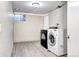The laundry room has vinyl floors and updated washer and dryer appliances at 2921 E Colorado Ave, Denver, CO 80210