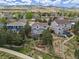 Aerial view of the property showcasing the home, backyard, and surrounding neighborhood with mature trees at 7888 Canvasback Cir, Littleton, CO 80125
