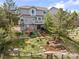 Expansive backyard featuring a deck, patio, fire pit, swing set, and lush landscaping for outdoor enjoyment at 7888 Canvasback Cir, Littleton, CO 80125