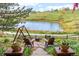 Inviting backyard seating area with a fire pit and scenic pond view for relaxing outdoor enjoyment at 7888 Canvasback Cir, Littleton, CO 80125