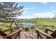 Inviting backyard seating area with a fire pit and scenic pond view for relaxing outdoor enjoyment at 7888 Canvasback Cir, Littleton, CO 80125
