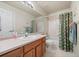 Neutral bathroom featuring a tub/shower combination, a wooden vanity and neutral finishes at 7888 Canvasback Cir, Littleton, CO 80125